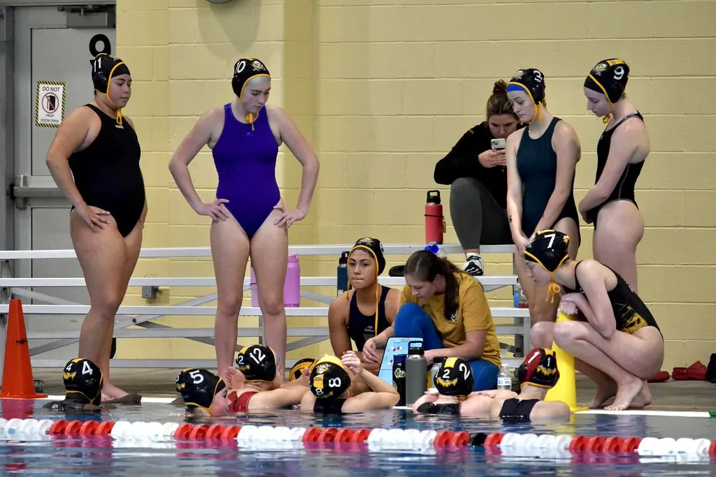Players and coaches gathered on the pool deck between games