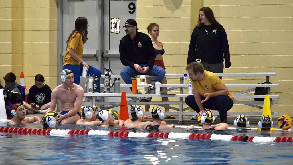 Coaches and players along the pool deck during the tournament