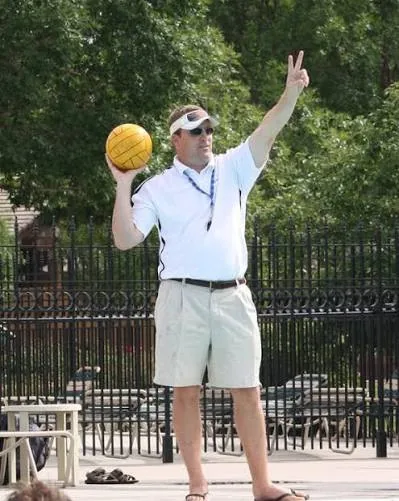 Grier Laughlin on the pool deck, holding a water polo ball